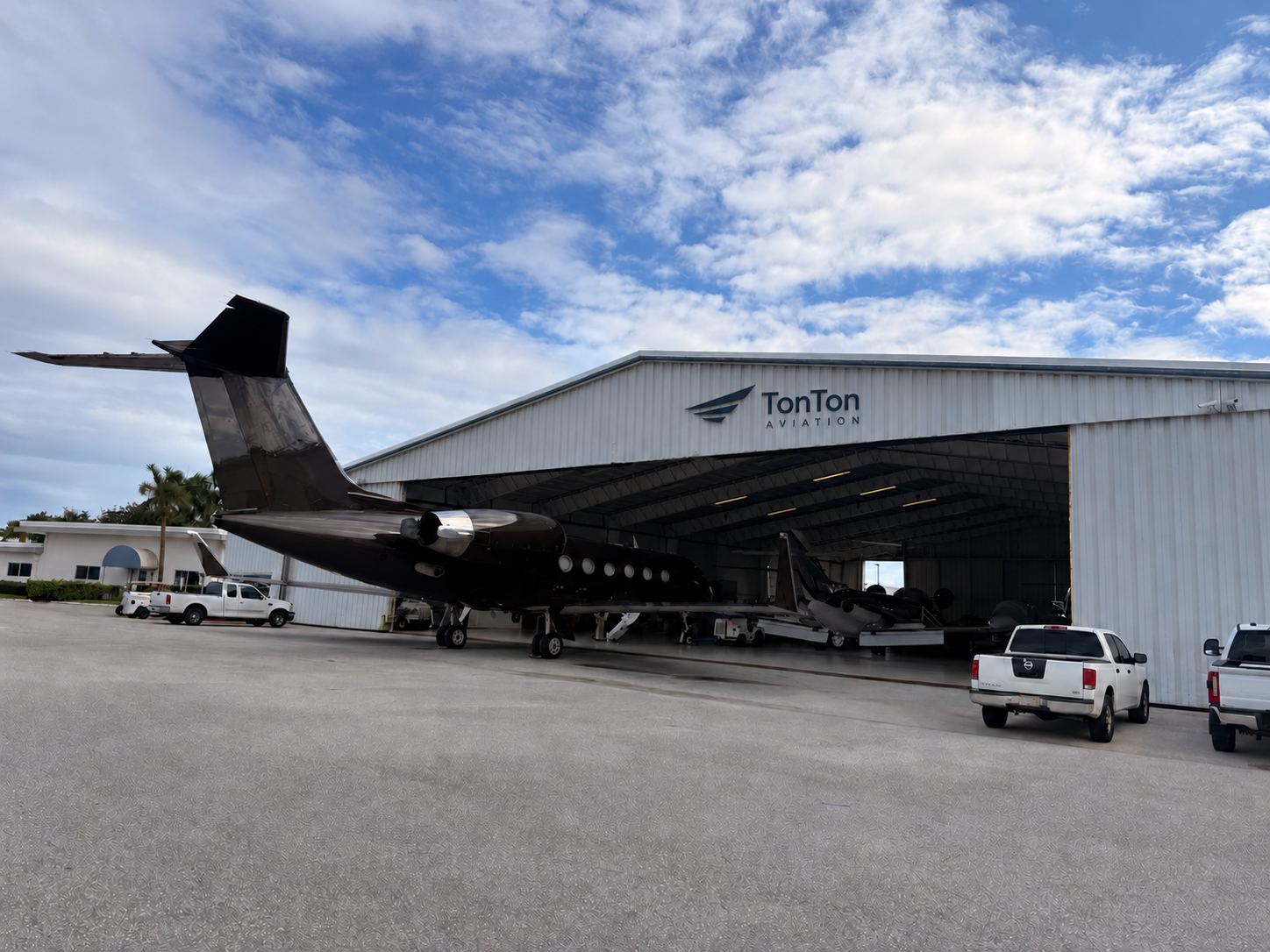 TonTon Aviation brand concept showing a jet parked partly inside a hangar.